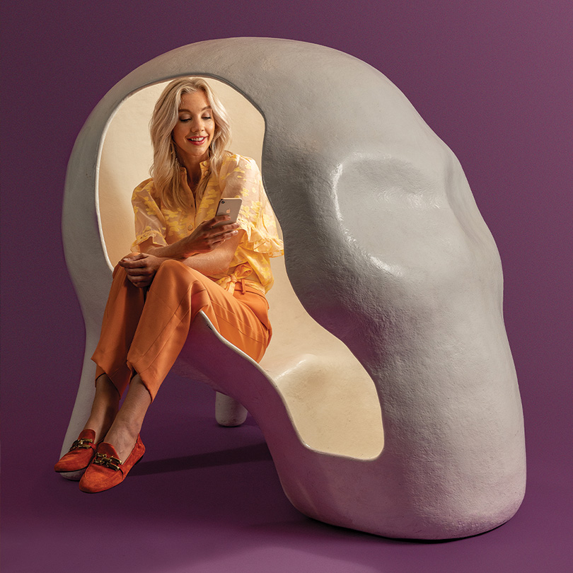 girl in a skull shaped chair made by Atelier Van Lieshout