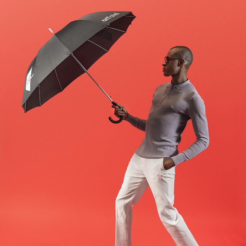man with art'otel umbrella