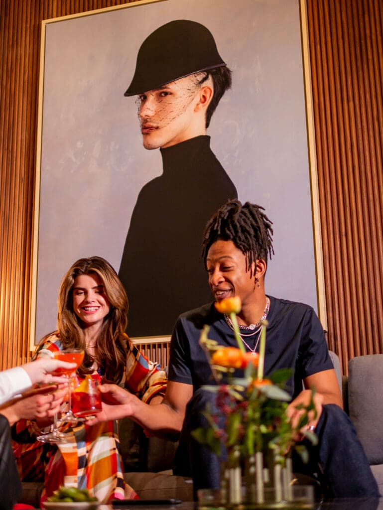 couple drinking Negroni at art'otel Battersea Power Station lobby.